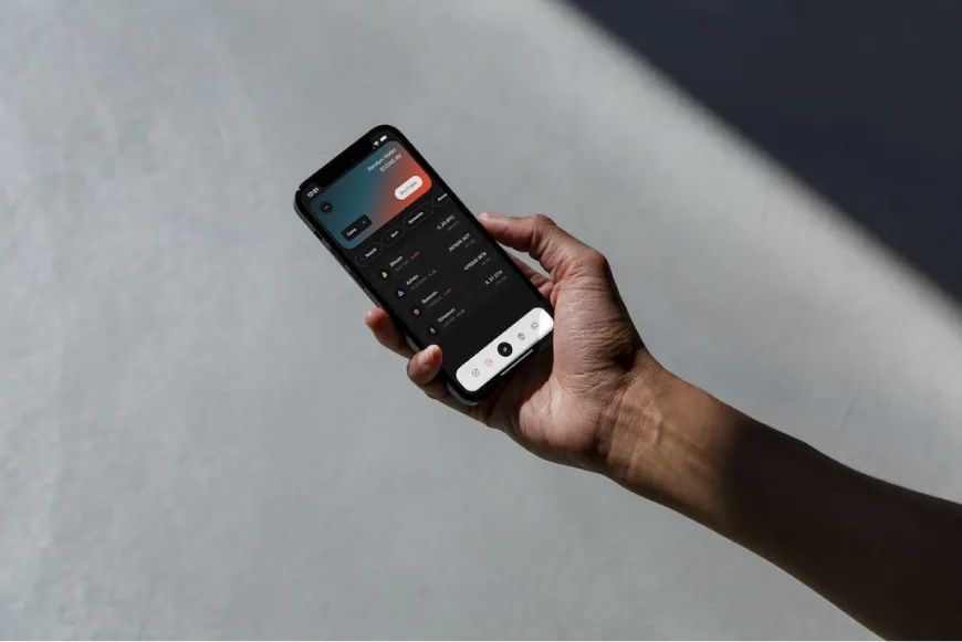 Hands holding a phone displaying the GeoDB mobile app interface